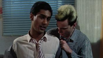 My Beautiful Laundrette: A young White man removes a young British Asian man’s suit jacket from behind
