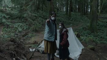 Lazareth movie: Sarah Pidgeon stands next to Katie Douglas in face masks, holding out a knife