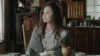 Lazareth movie: Ashley Judd sits at a kitchen table, shawl around her shoulders