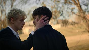Leviticus Movie: Both dressed in black suits, Ryan places his hands on Naim's face in a loving way