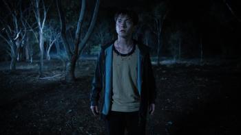 Leviticus Movie: Looking injured and worn-out, Naim (Joe Bird) regards something warily in the dark woods