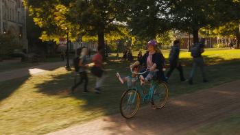 Life of the Party Movie: Deanna rides a bike on campus