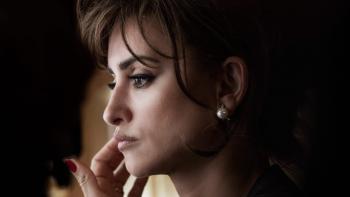 L’immensità: A close-up of Penelope Cruz's face in profile as she raises her hand to her cheek