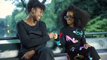 Little Movie: April fistbumps young Jordan on a park bench