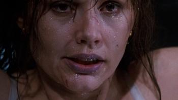 The Long Kiss Goodnight: A close-up of Geena Davis' wet face and hair, scratches on her nose and chin