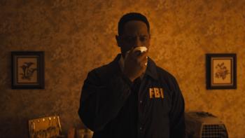 Longlegs Movie: Wearing his FBI jacket to a crime scene, Agent Carter (Blair Underwood) holds a handkerchief over his nose