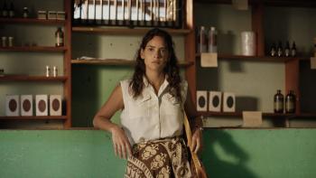 Los Frikis movie: Adria Arjona leans on a counter