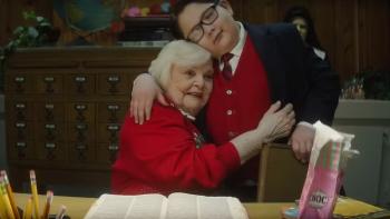 Lost & Found in Cleveland movie: June Squibb is seated at the teacher's' desk, hugging a boy