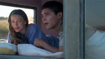 Lost in the Night: A man and woman by a window