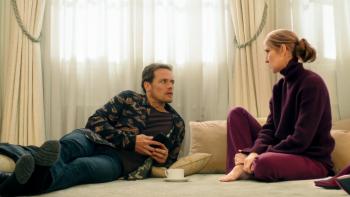 Love Again Movie: Sam Heughan lounges on the floor, propped up on his elbow, while talking to Celine Dion, who's sitting next to him