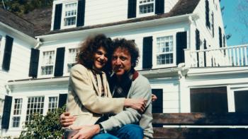 Love, Gilda Movie: Gene Wilder picks up Gilda in front of a white house and they both smile into the camera. 
