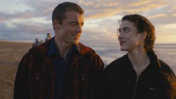 Love of Your Life movie: Gabriel Basso and Margaret Qualley smile lovingly at each other on a beach