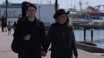 Niall McNamee and Shana Swash walk hand in hand down a pier