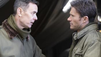 Lucky Strike Movie: Col. Neale (Colin Hanks) speaks seriously to Col. Castle (Scott Eastwood) outside a tent