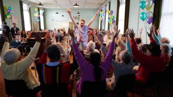 Allelujah: A nurse on a geriatric ward throws her hands up in the air during a celebratory game with her patients.