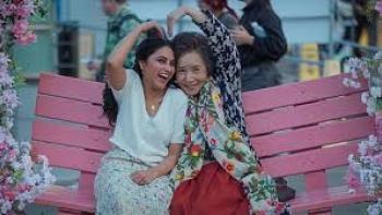 Made in Korea: Indian young woman and Korean older woman are playful on bench
