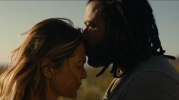 Magic Hour movie: Charlie (Daveed Diggs) kisses Erin's (Katie Aselton) forehead in a desert setting