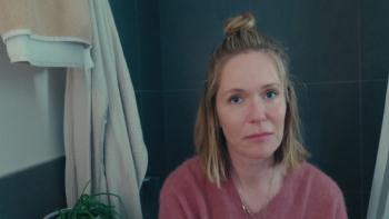 Magic Hour movie: Erin (Katie Aselton) sits in a bathroom with towels hanging around her