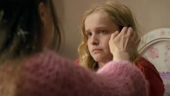 Magnetosphere: From behind her mother's hand reaches for Maggie's hair while Maggie looks distressed and tearful.