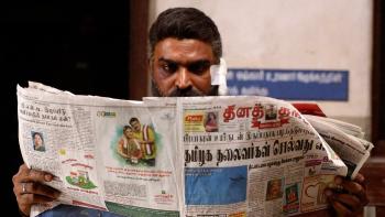 Maharaja: An Indian man reads a newspaper