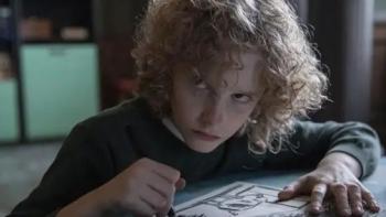 Marionette: Manny holds a crayon over a drawing, an angry look on his face.