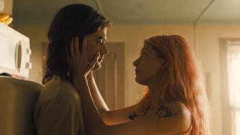 Marmalade: Camila Morrone holds Joe Keery's face between her hands as they look at each other intensely in a living room