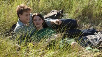 Marrowbone: Couple lying in grass, smiling and pointing, with greenery around