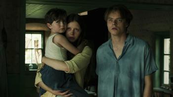 Marrowbone: A woman holds a child; a man stands beside them, all looking serious