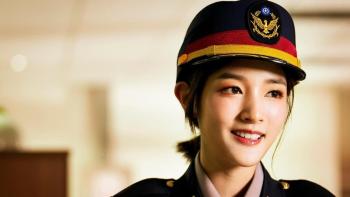 Marry My Dead Body movie: Taiwanese police woman in hat and uniform center right smiles while looking off to the side