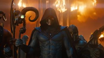 Masters of the Universe Movie: Skeletor, wearing a hood over his skull face, looks menacing in front of patches of fire