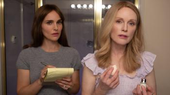May December Movie: Natalie Portman takes notes on a yellow pad while speaking to Julianne Moore while she's putting on makeup at a bathroom mirror