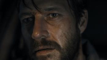 Mercy Road: A close-up of a dishevelled, bearded White man in a car.
