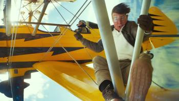 Mission: Impossible - The Final Reckoning movie: Ethan Hunt (Tom Cruise) hangs from the wing strut of a biplane in midair