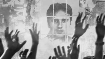 Miguel Ángel Blanco: The 48 Hours that Changed Spain Movie: Hands raised in front of a monochrome photo of a man's face on a wall.