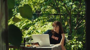 Mile End Kicks movie: Barbie Ferreira, in a SPIN magazine T-shirt, sits outside while working on a laptop