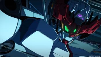 Mobile Suit Gundam GQuuuuuuX: Beginning Movie: A gundam robot with lit up green eyes poses ready for a fight