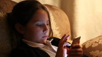 Molly vs the Machines: Ivy Blackshaw plays Molly in a reconstruction as she sits in a dimly-lit room scrolling on her phone