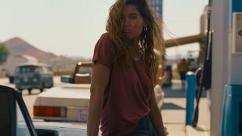 Monica Movie: A woman pumps gas with the wind in her hair