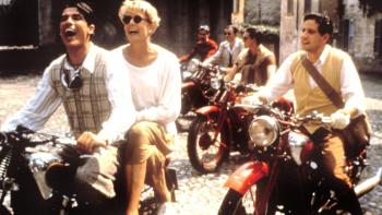 A Month by the Lake: Vanessa Redgrave smiles joyously, sitting behind a young man on the back of his motorbike, other motorbikes riding alongside