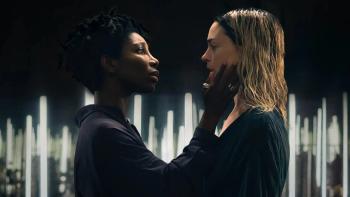 Mother Mary: Michaela Coel holds her hand up to Anne Hathaway's face as the two stare at each other, the background illuminated by white lights