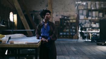 Mother Mary: Michaela Coel looks reflective as she leans against a desk in a dimly-lit studio