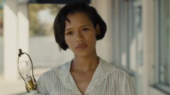 Mother, Couch Movie: Outside the furniture store, Bella (Taylor Russell), holding a lamp, looks kind and concerned
