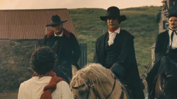 Harvest: Three men on horseback talk to another man standing