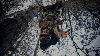 Murder Company movie: William Moseley hangs upside down in a tree, reaching out