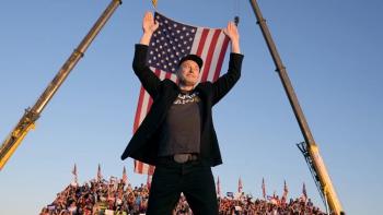 Musk movie: Elon musk stands in front of a crowd and the American flag