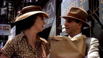 Enemies, a Love Story: Ron Silver holding groceries while talking to Anjelica Huston