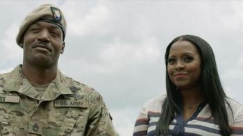 My Brother's Keeper Movie: A Black soldier wearing a beret stands outside speaking to a young Black woman