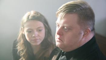 My Feral Heart: Shana Swash and Steven Brandon sit together wearing black and looking sad