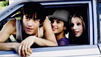 Mysterious Skin Movie: Three people smiling from a car window, one wearing a hat.