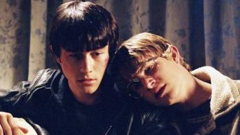 Mysterious Skin Movie: Two young men, one resting his head on the other's shoulder, sitting indoors.